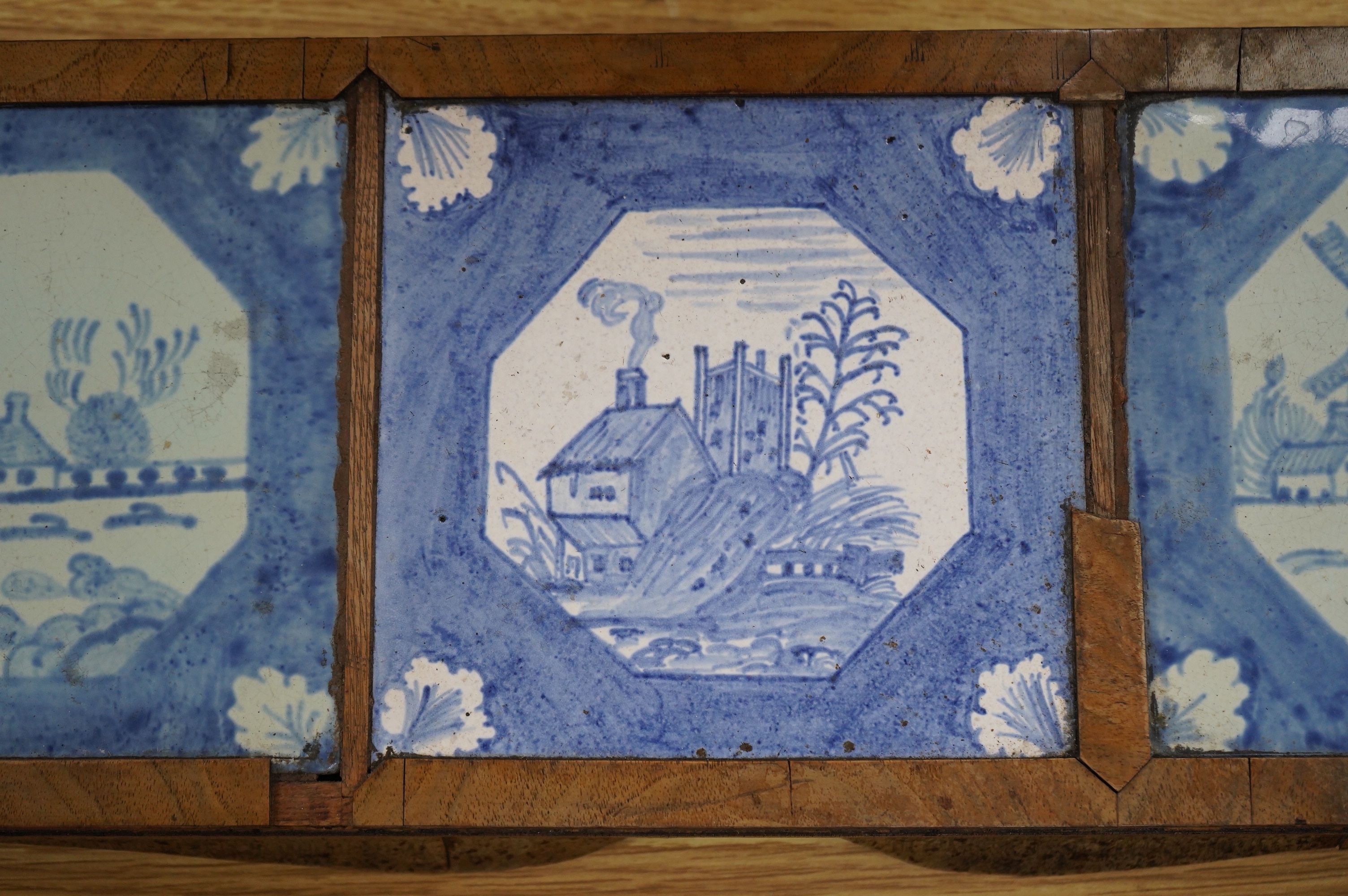 A 19th century Delft tile inset walnut stand, 49cm wide. Condition - poor